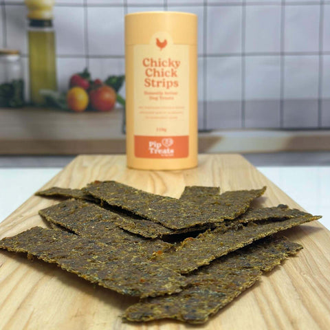 Chicky Chick Strips air-dried treats on a timber board — Pip Eats